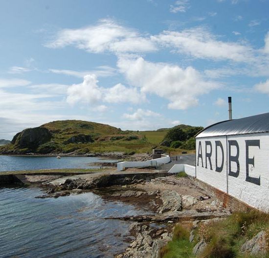 Das weiße Lagerhaus mit großen Buchstaben Ardbeg liegt direkt am Meer.